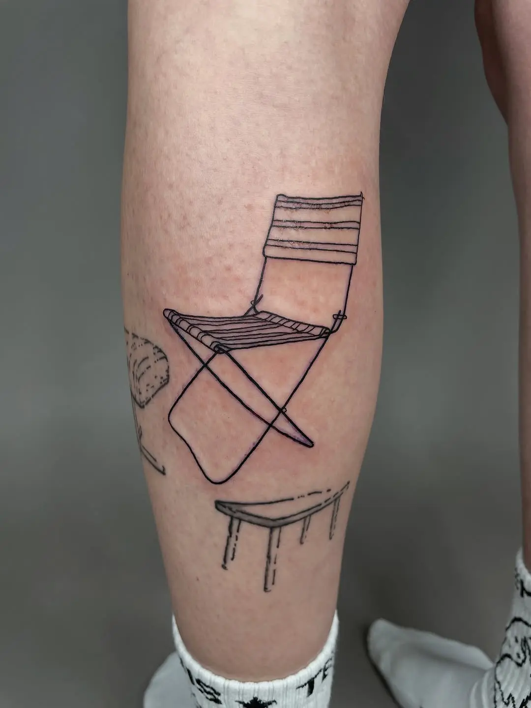 Minimalist chair tattoo showcasing unique artistry