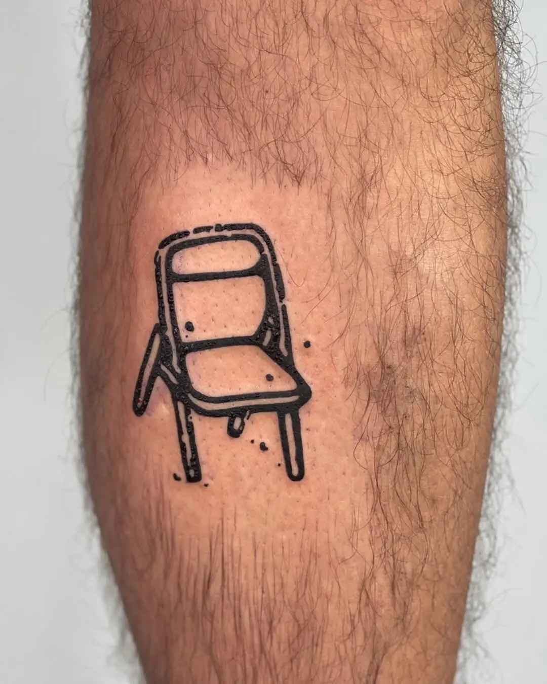 Minimalist Chair Tattoo on a Leg