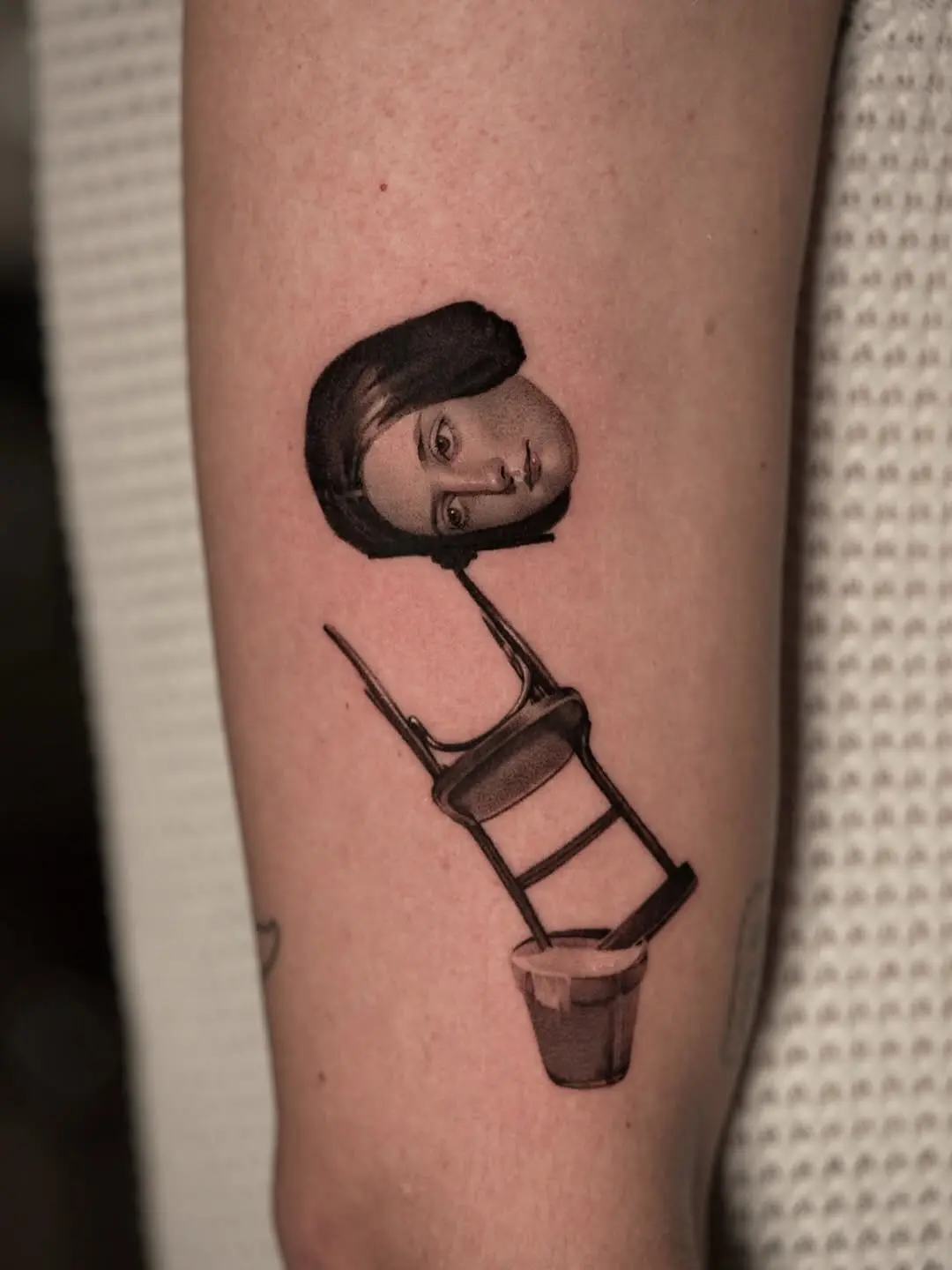 Unique chair tattoo with a surreal twist