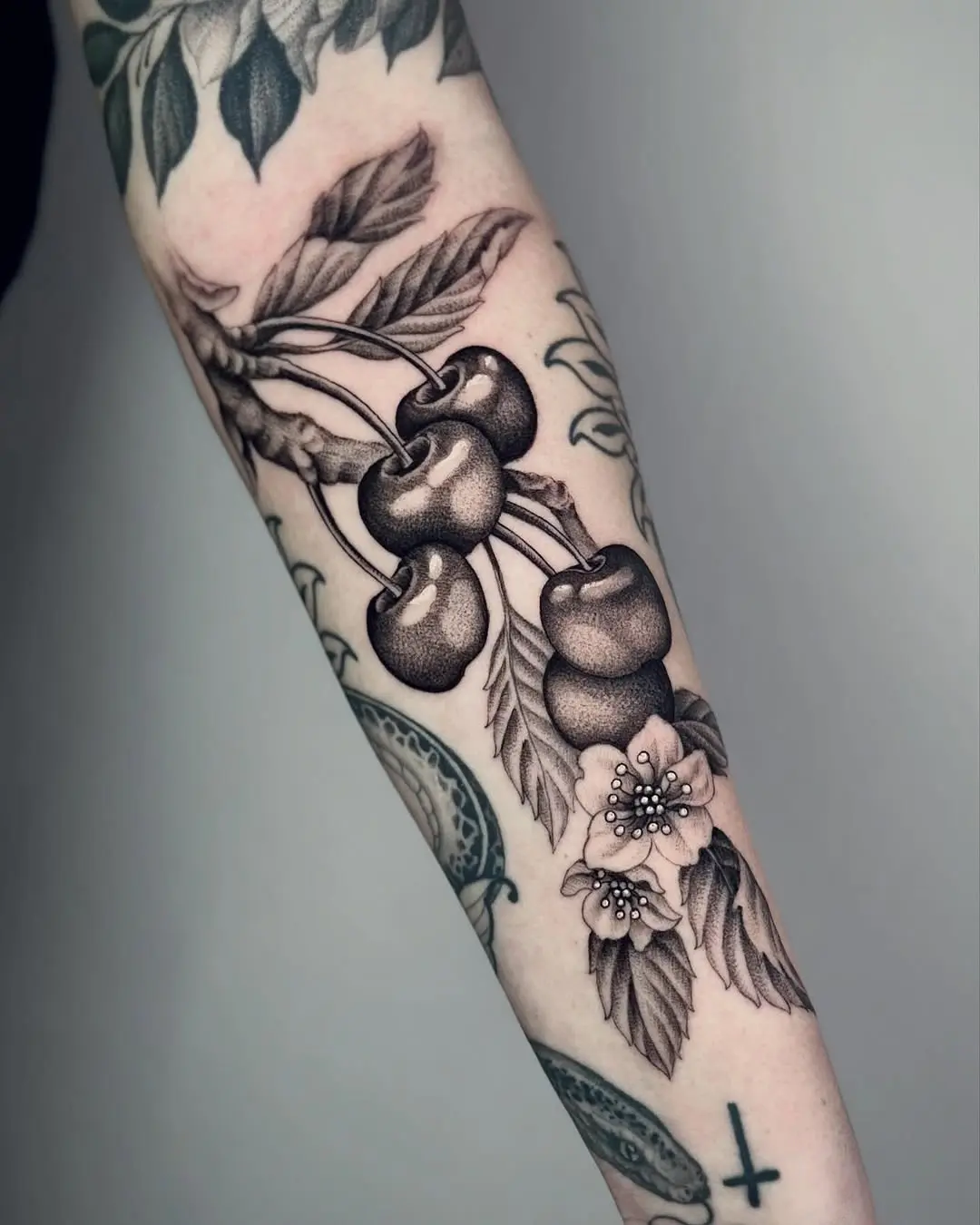 Intricate black and gray cherry tattoo design