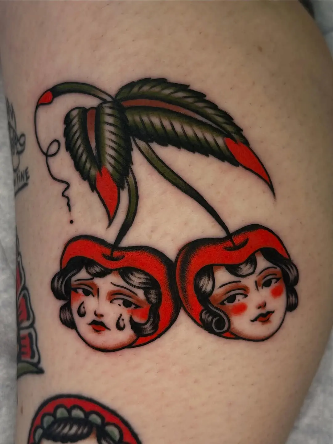 Whimsical Cherry Tattoos Featuring Dual Faces