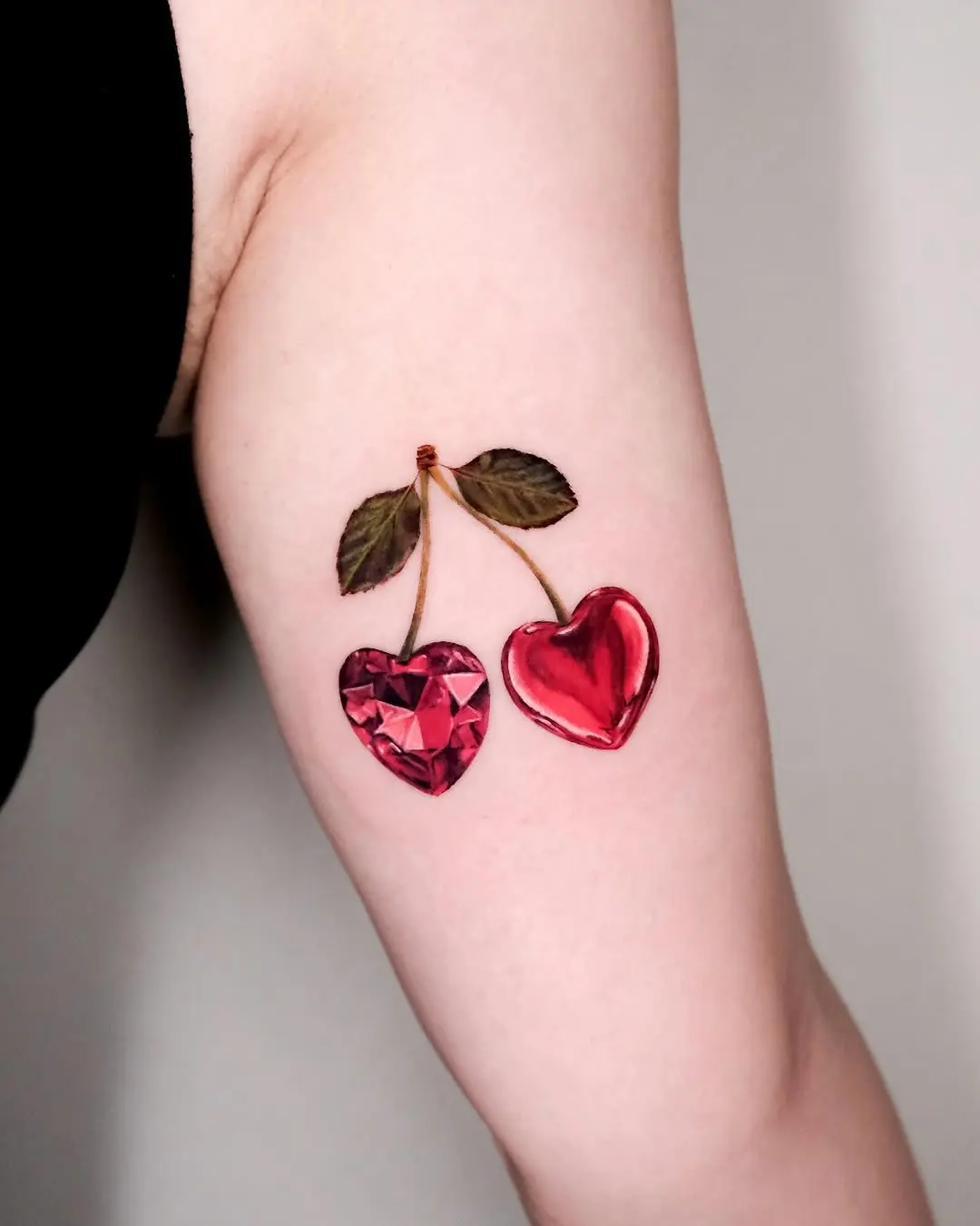 Vibrant cherry tattoo with a modern twist