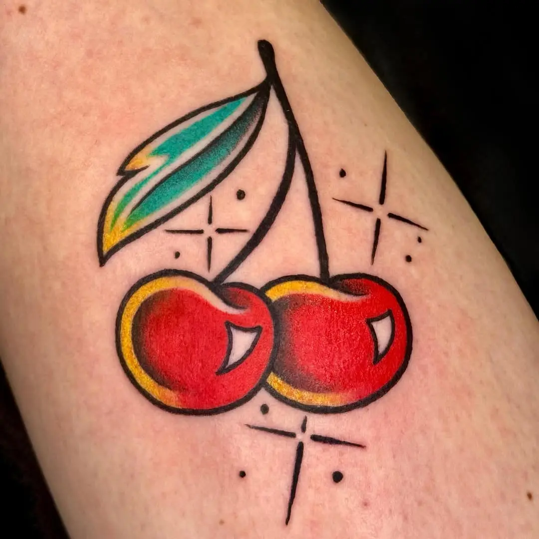 Colorful cherry tattoo with playful sparkles