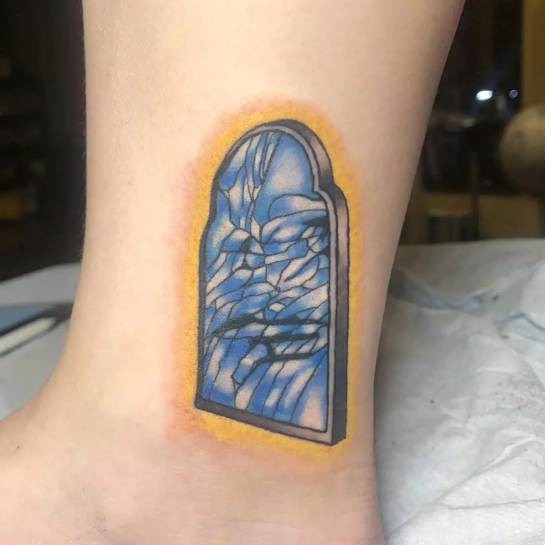 Eye-catching cracked mirror tattoo with vibrant colors