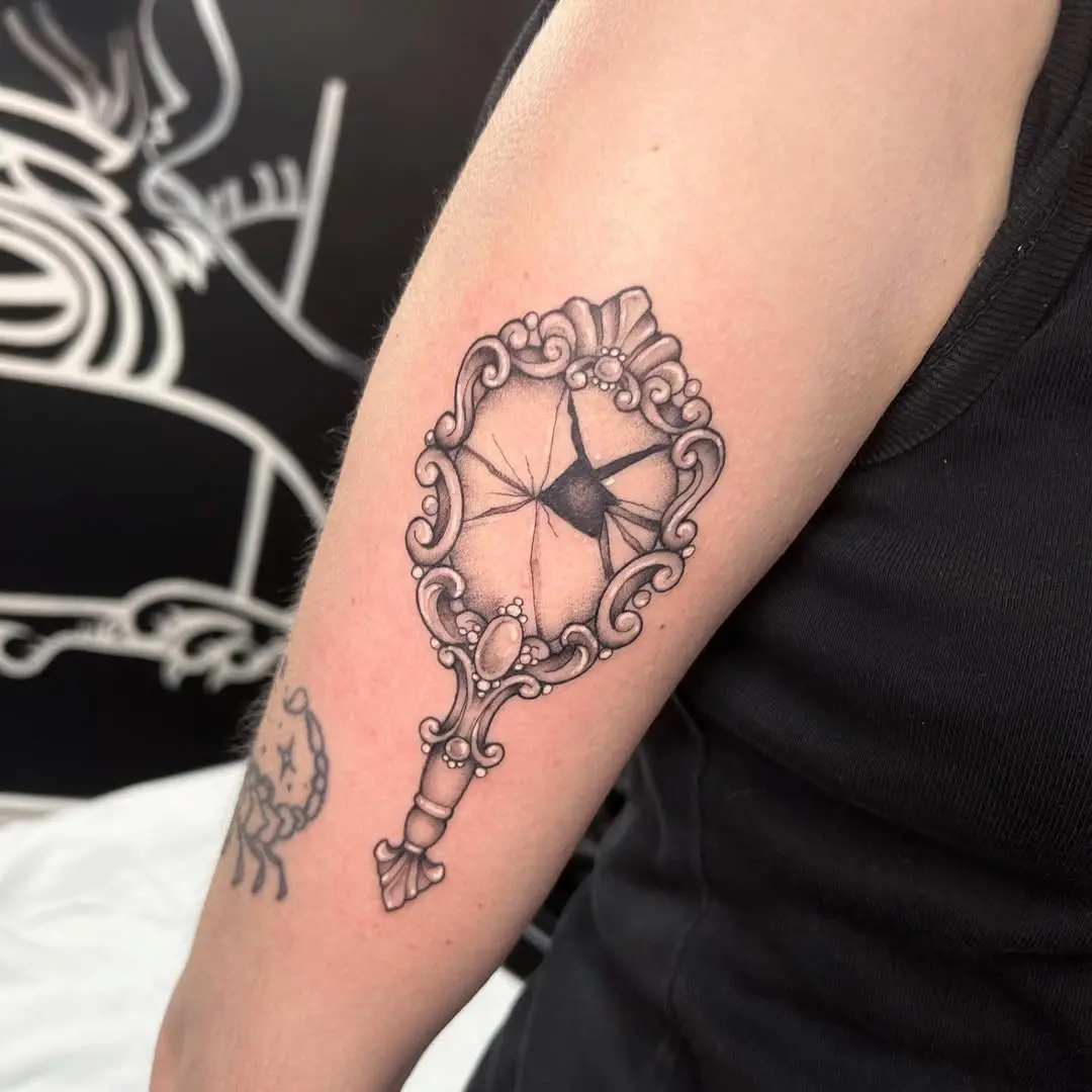 Elegant cracked mirror tattoo showcasing intricate details