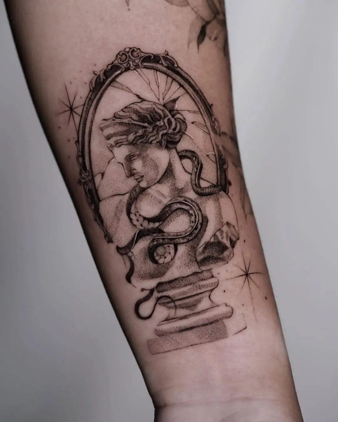 Elegant cracked mirror tattoo with mythological bust