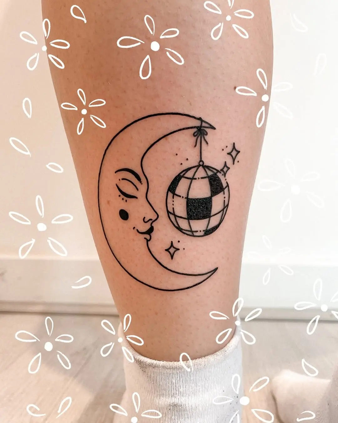 Whimsical crescent moon and disco ball tattoo