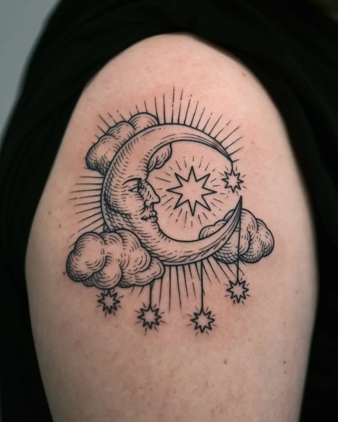 Detailed crescent moon tattoo with celestial elements