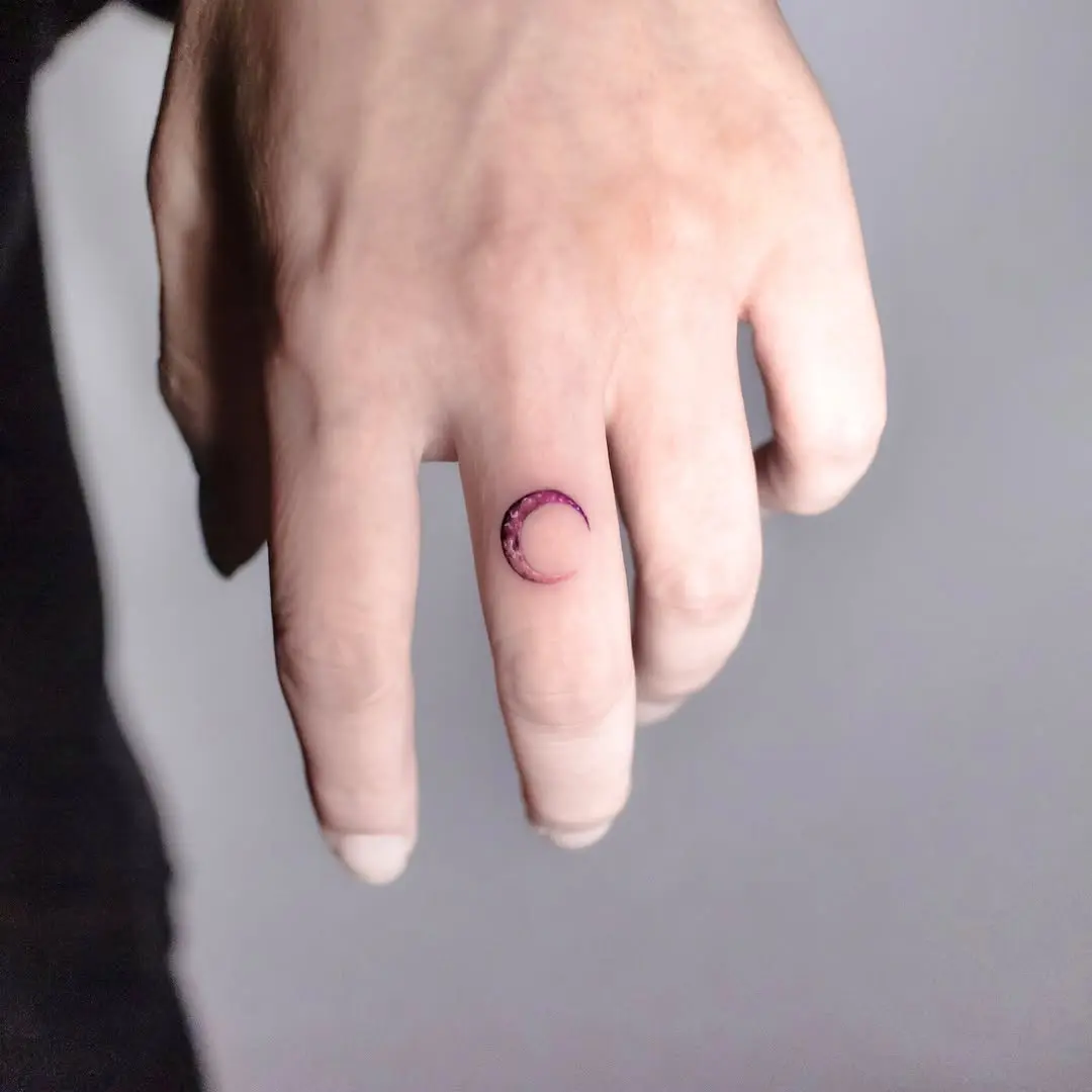 Charming crescent moon tattoo on the finger