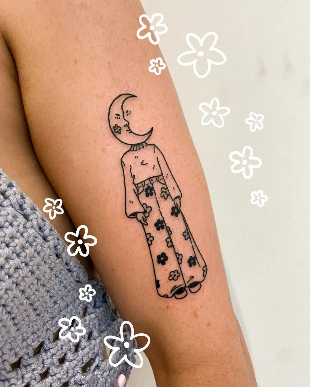 Whimsical crescent moon tattoo with floral vibes