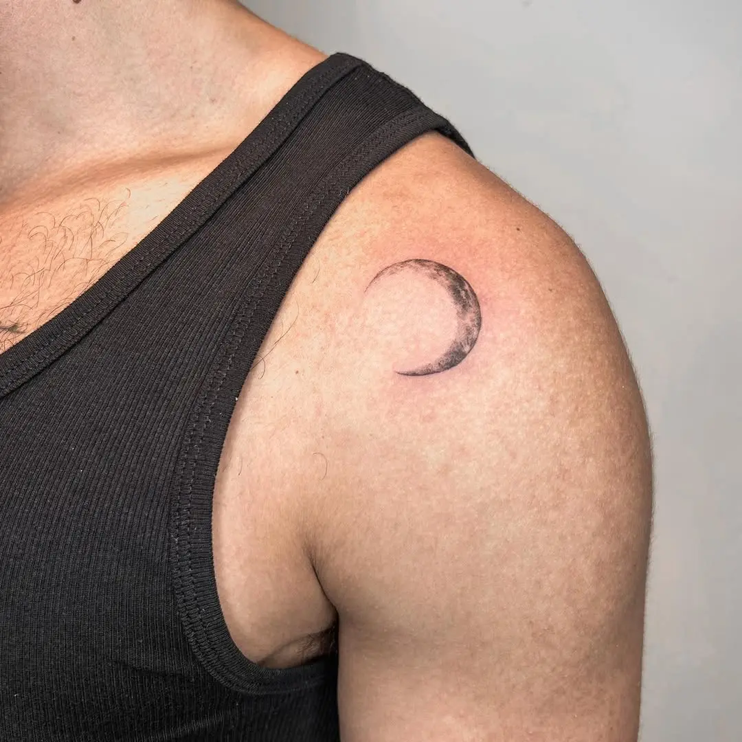 Minimalist crescent moon design on shoulder