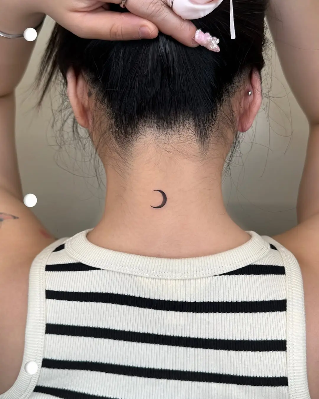 Elegant crescent moon tattoo on the neck