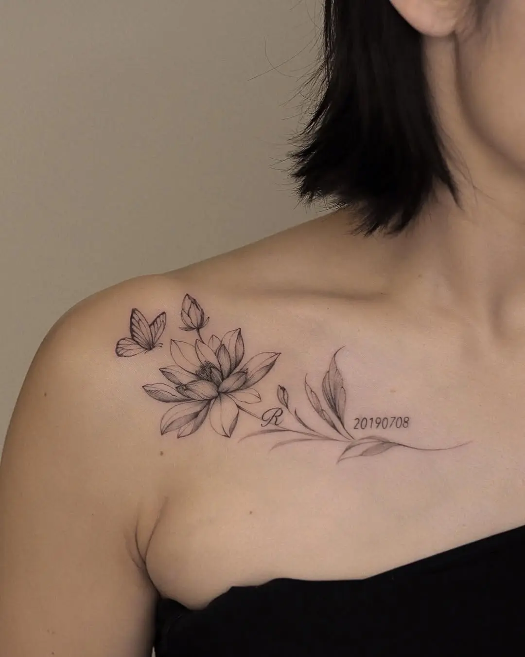 Elegant water lily tattoo surrounded by butterflies