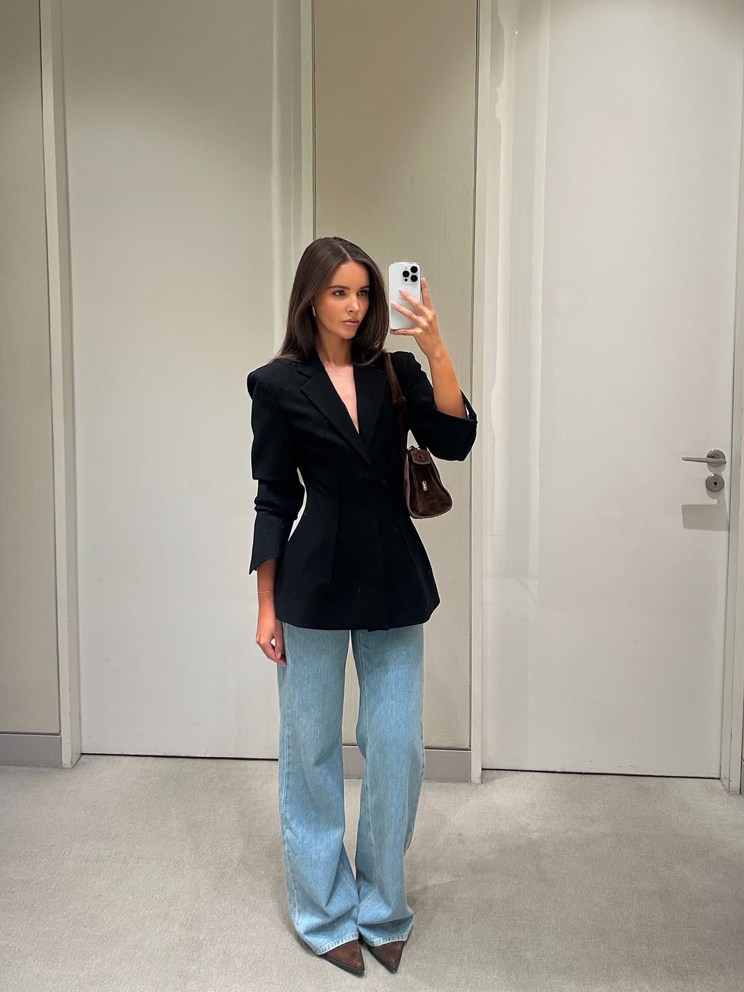 Chic black blazer styled with flared jeans
