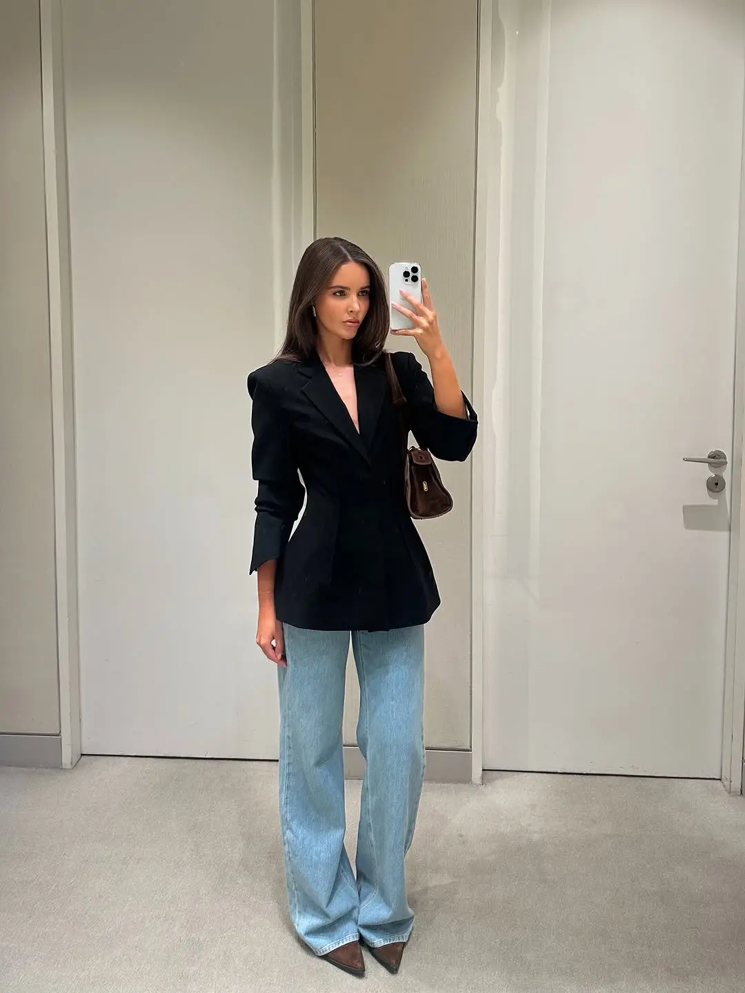 Chic black blazer styled with flared jeans