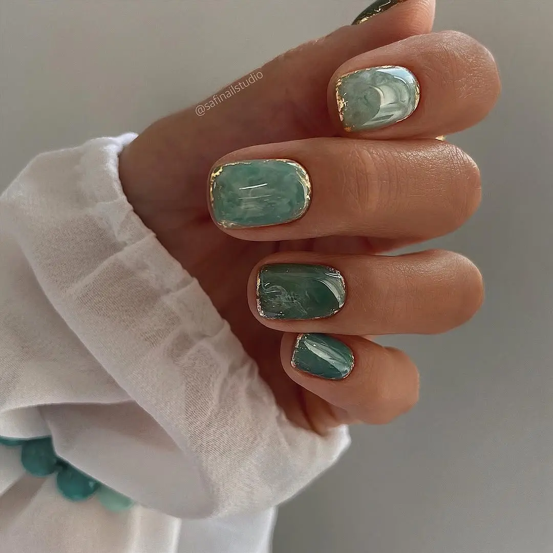 Trendy graduation nails with ocean vibes