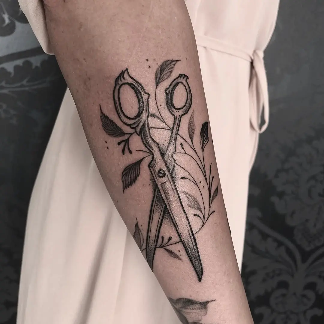 Elegant scissors tattoo with floral accents