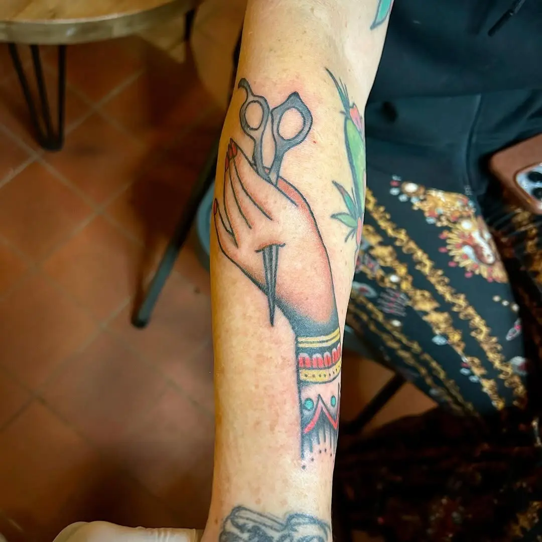 Stylish tattoo showcasing scissors and artistry