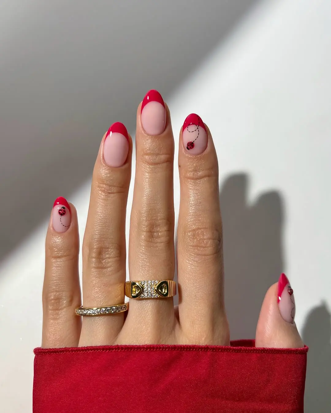 Charming ladybug nail design with red tips