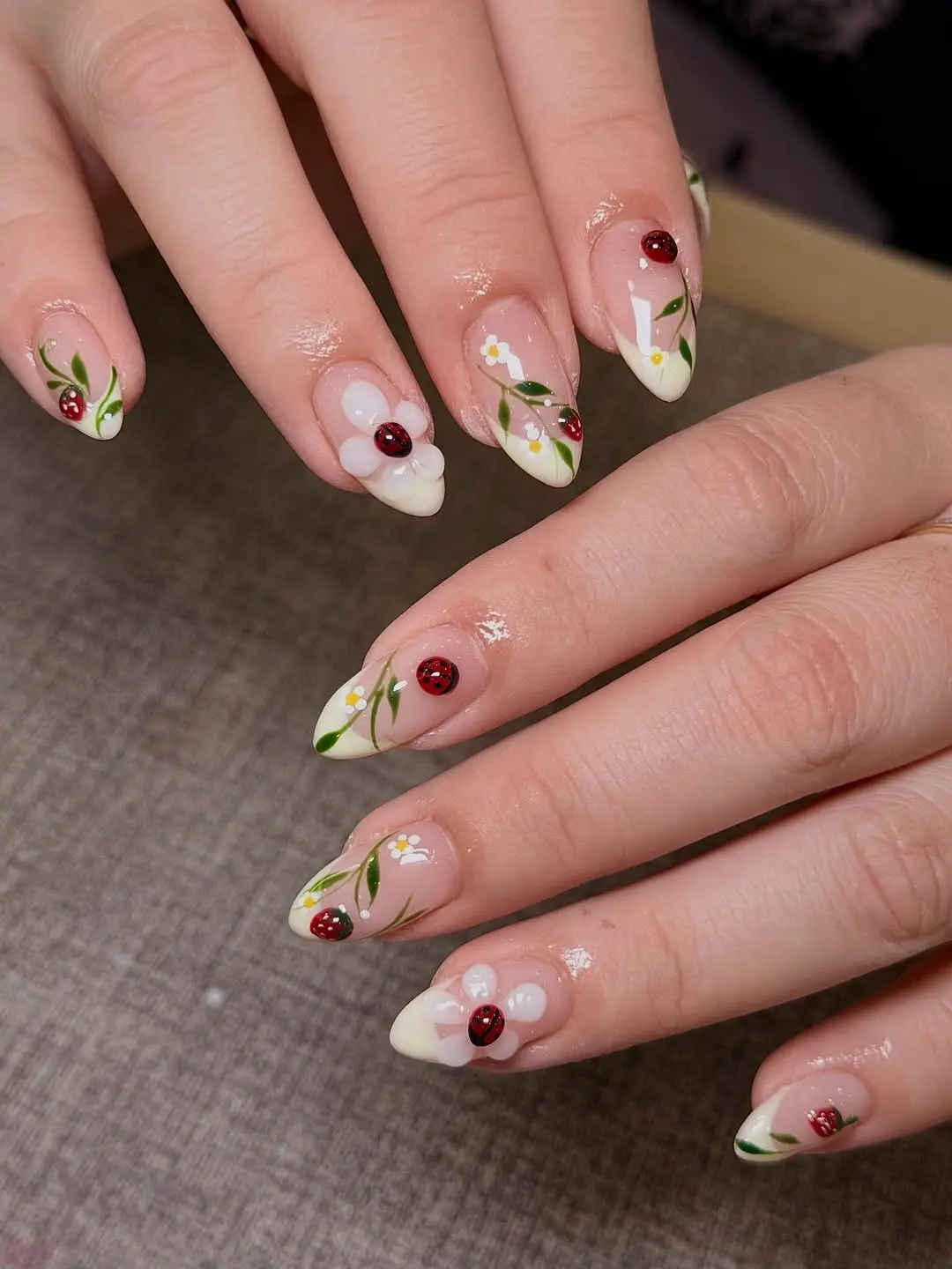 Charming ladybug nails with floral accents