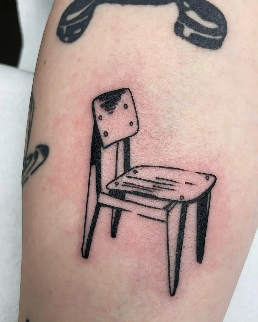 Stylish wooden chair tattoo in minimalist design
