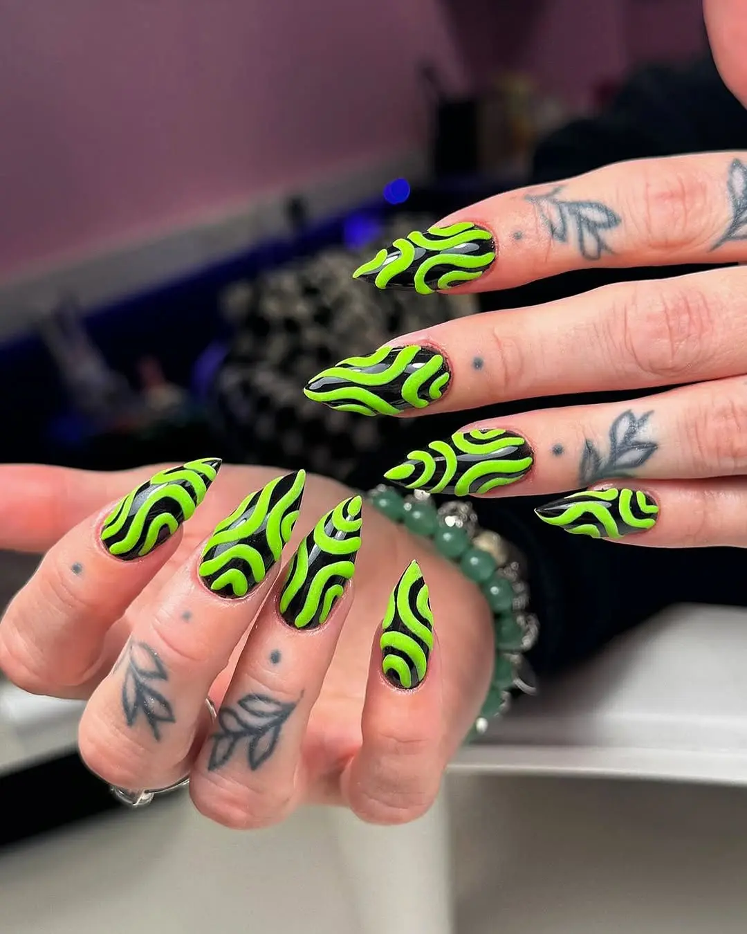 Vibrant green nails with eye-catching swirls