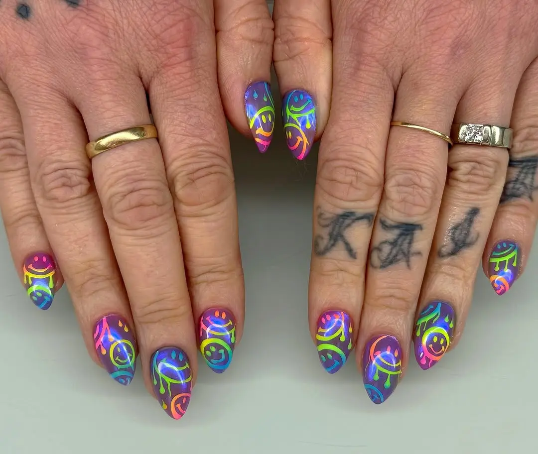 Vibrant neon nails with playful patterns and smiles