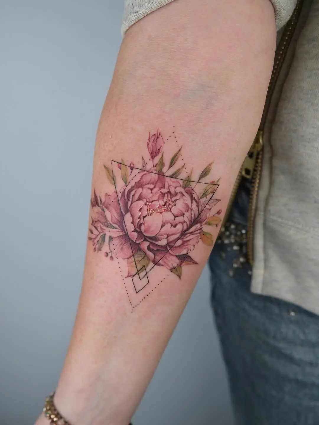 Elegantly crafted peony tattoo with geometric elements