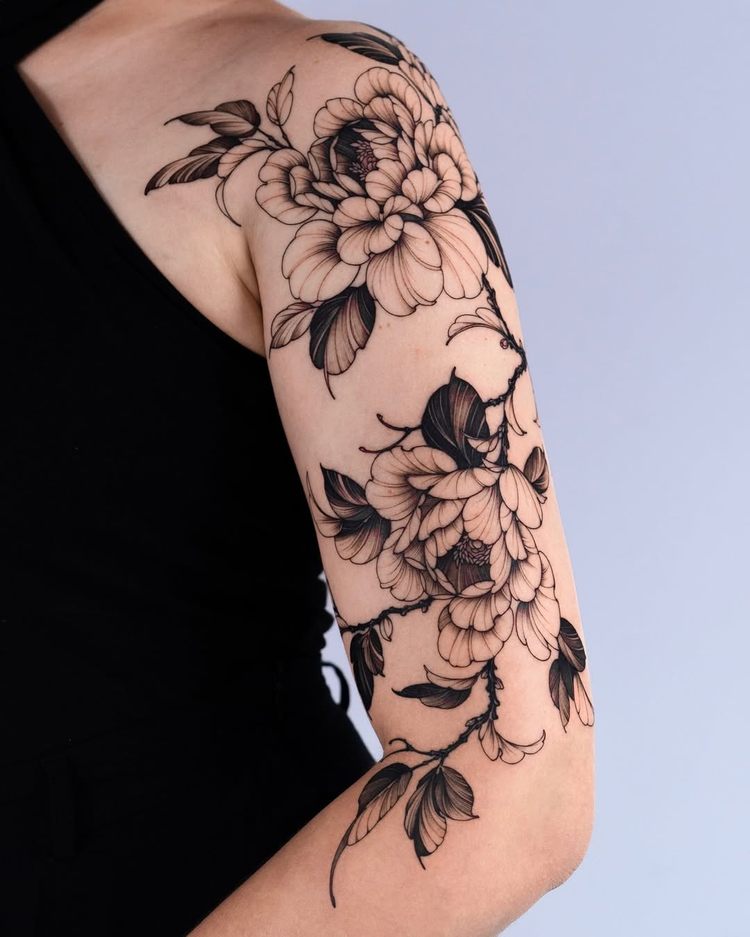 Elegant peony tattoo accentuating the arm
