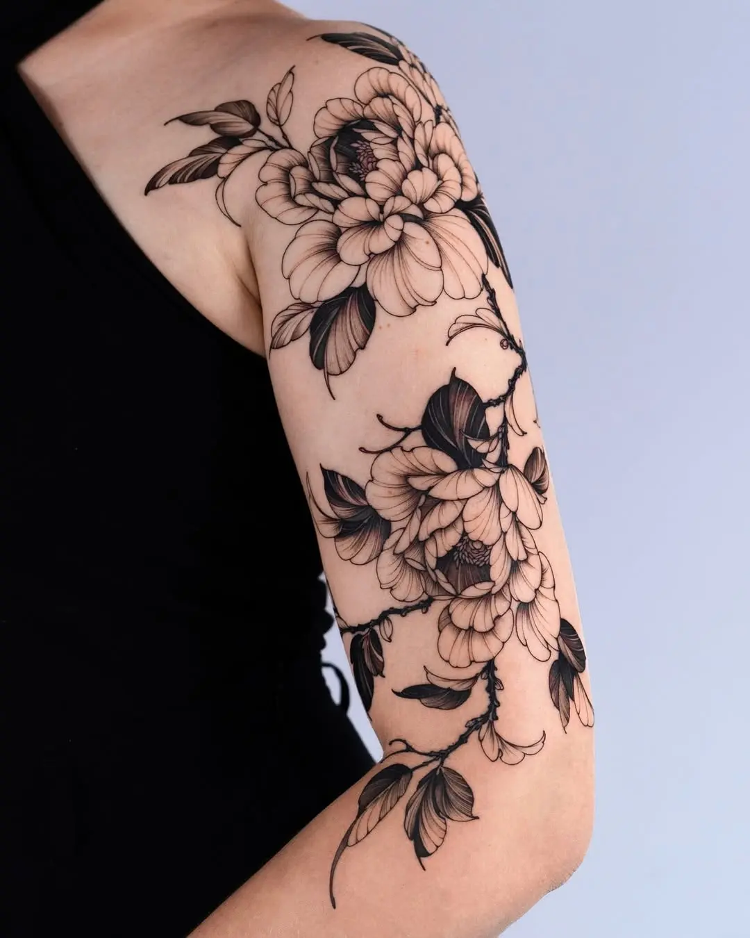 Elegant peony tattoo accentuating the arm