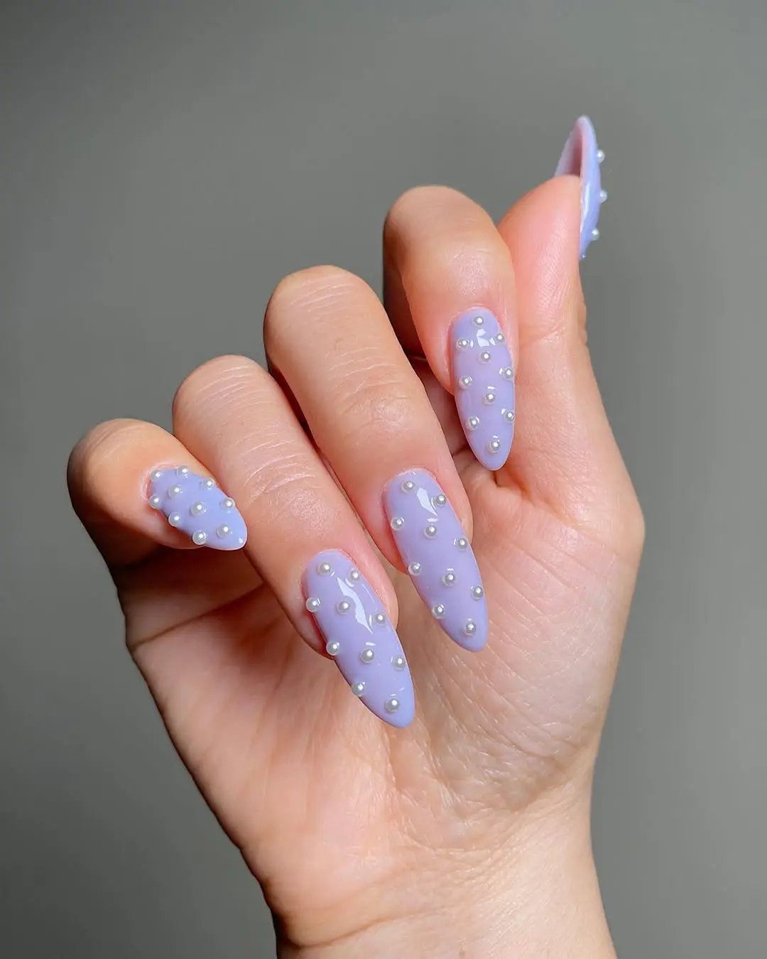 Chic periwinkle nails with stylish pearl accents