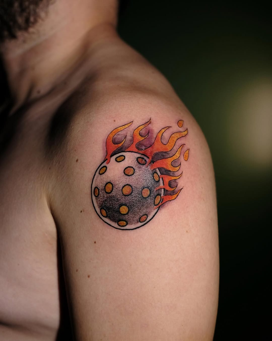 Dynamic pickleball tattoo with fiery design