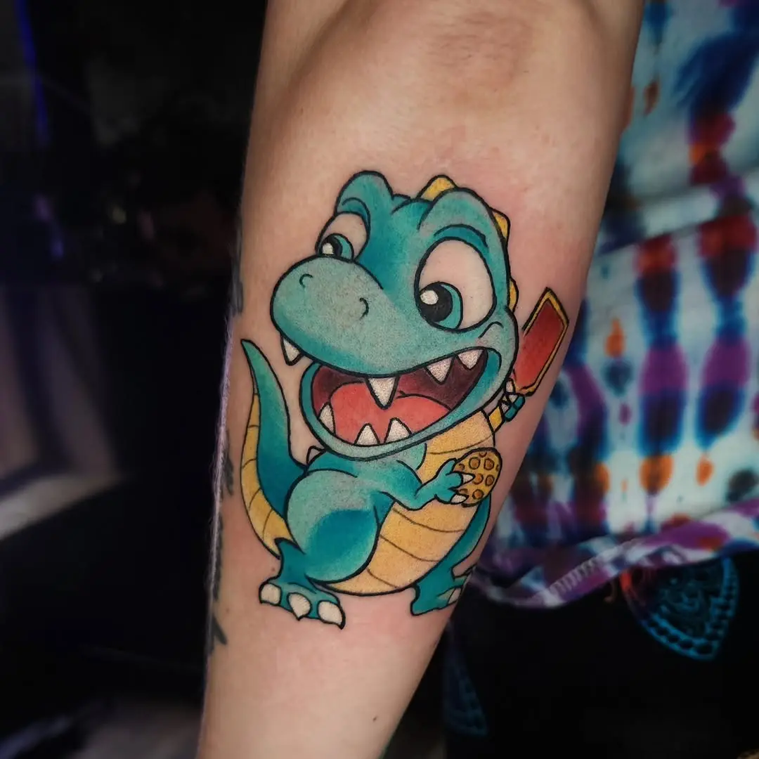Playful dinosaur tattoo with pickleball paddle