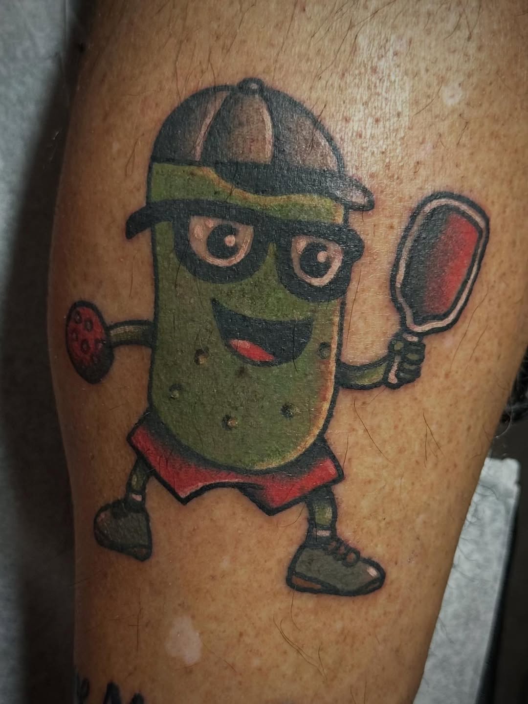 Playful pickleball tattoo with humorous vibes