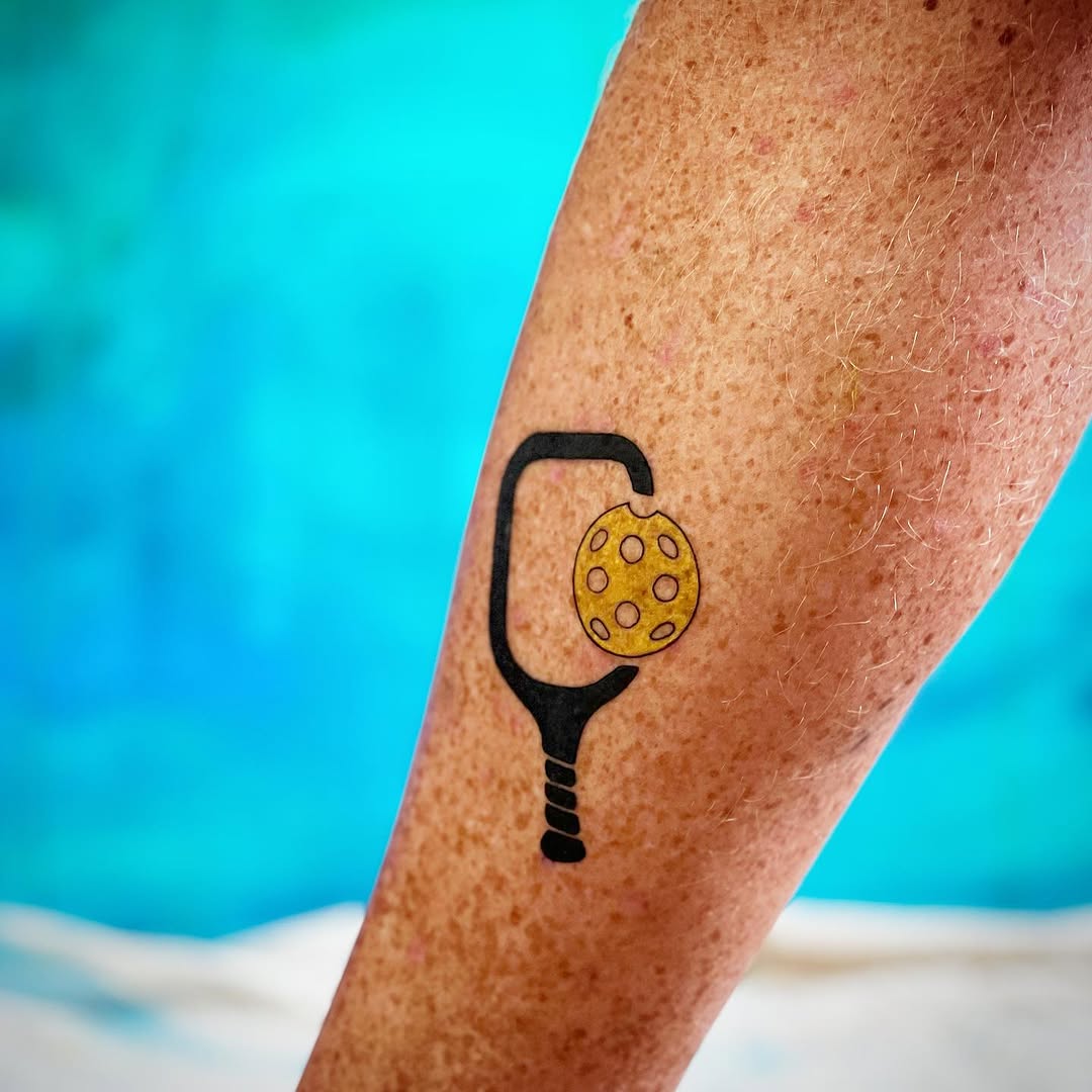 Unique pickleball tattoo on a player's leg