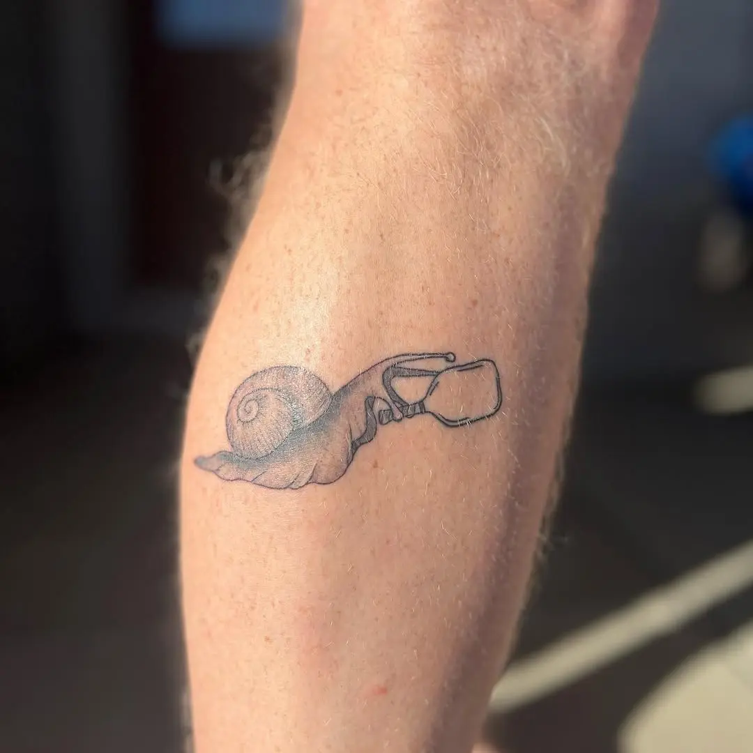 Unique Hand and Snail Pickleball Tattoo Design