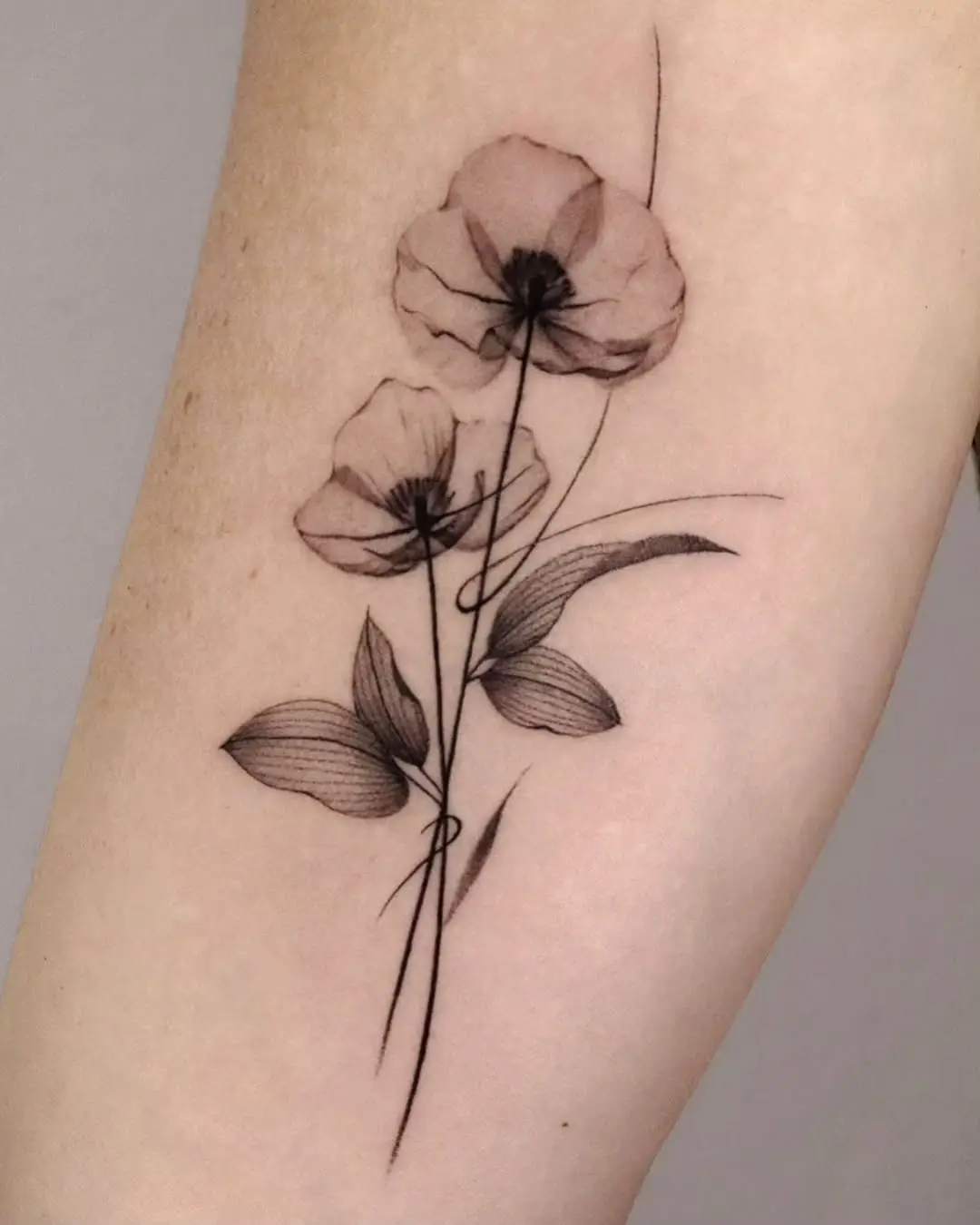 Delicate poppy flowers tattoo with graceful lines