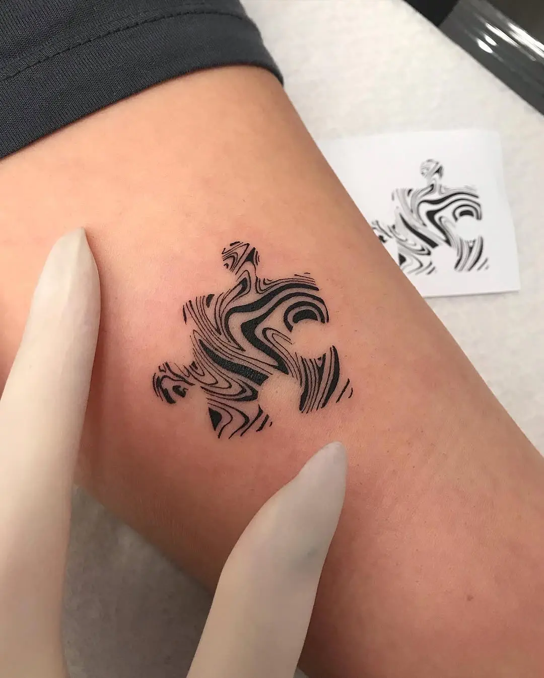 Sleek black and white puzzle tattoo design