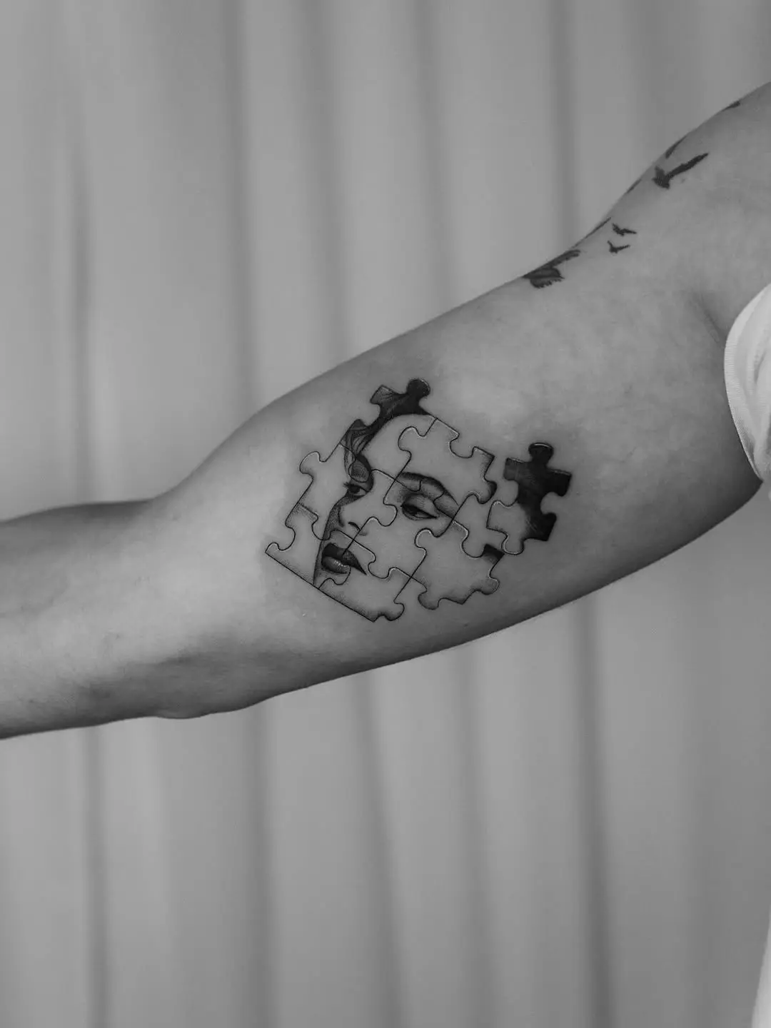 Intriguing puzzle tattoo blending faces and forms