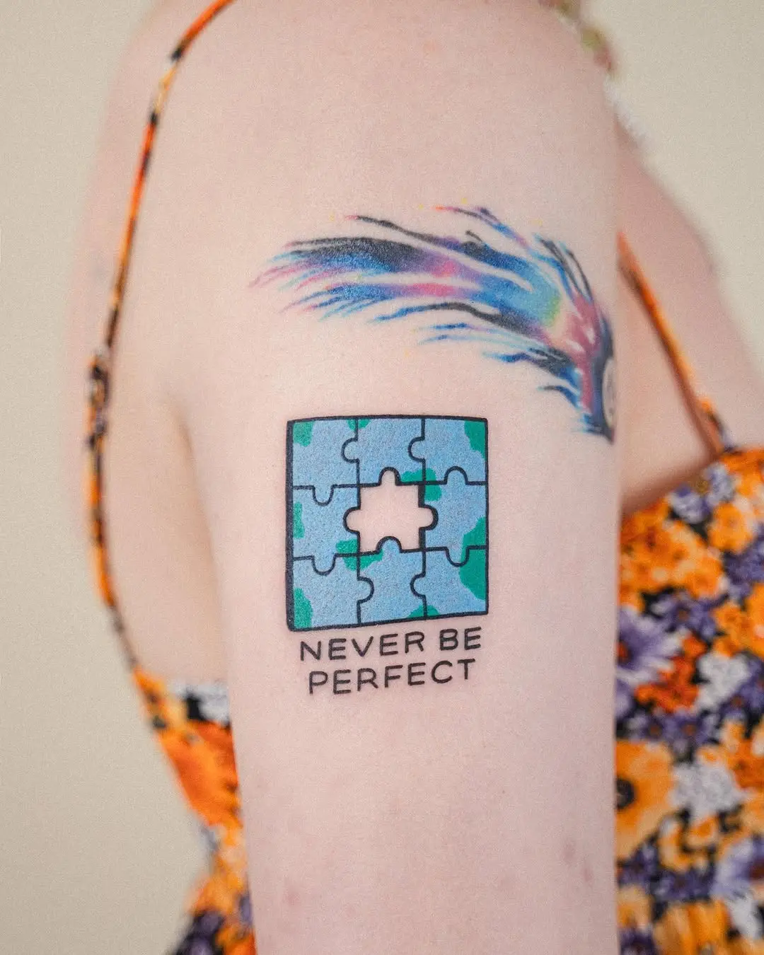 Colorful puzzle tattoo with empowering words