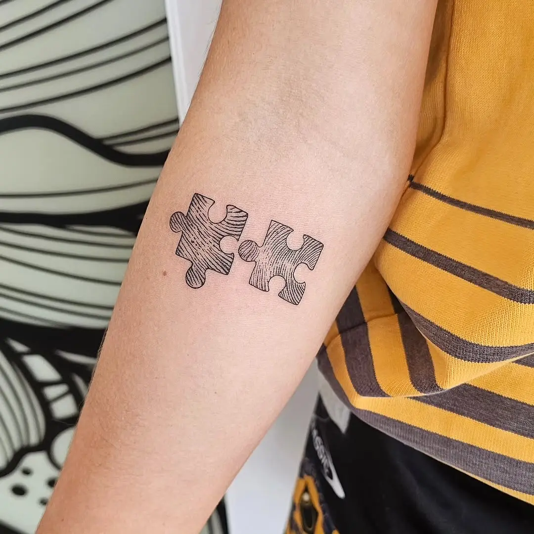 Stylish puzzle piece tattoo for connection lovers