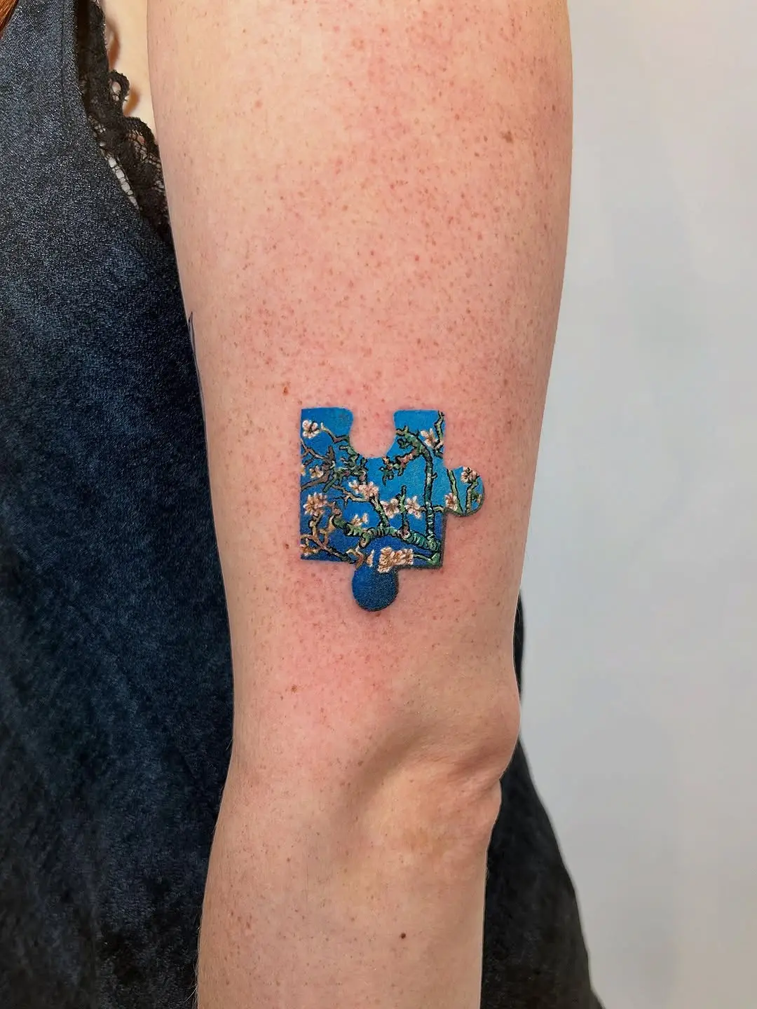 Vibrant Puzzle Piece Tattoo with Floral Patterns