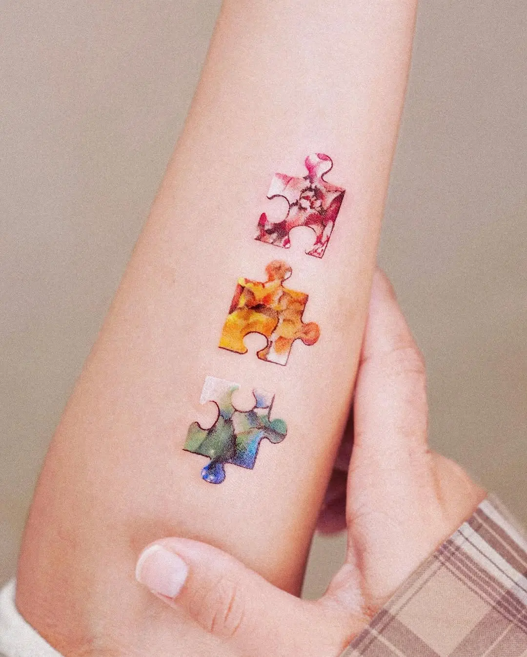 Colorful puzzle tattoos representing unique connections