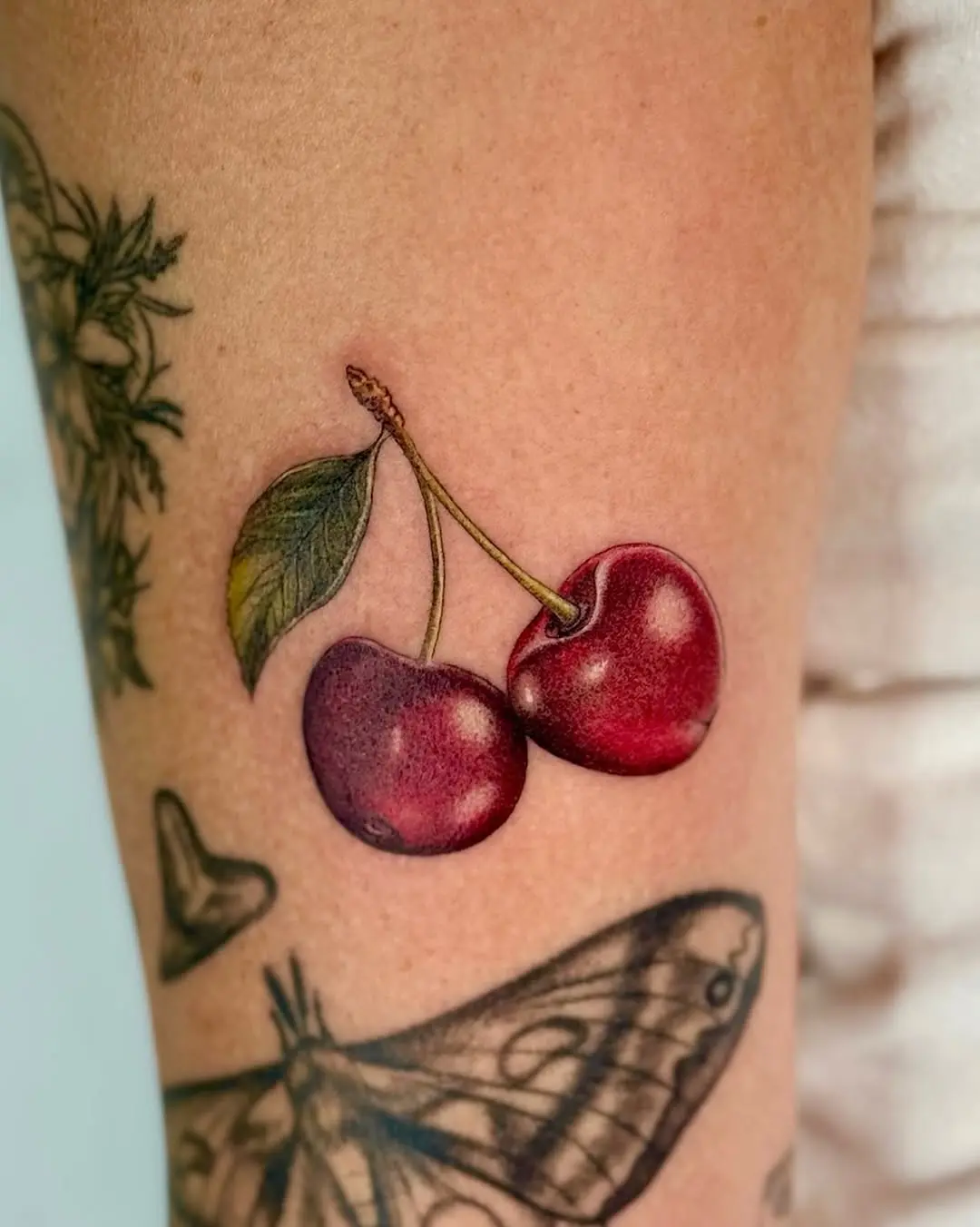 Stunning realistic cherry tattoo on skin
