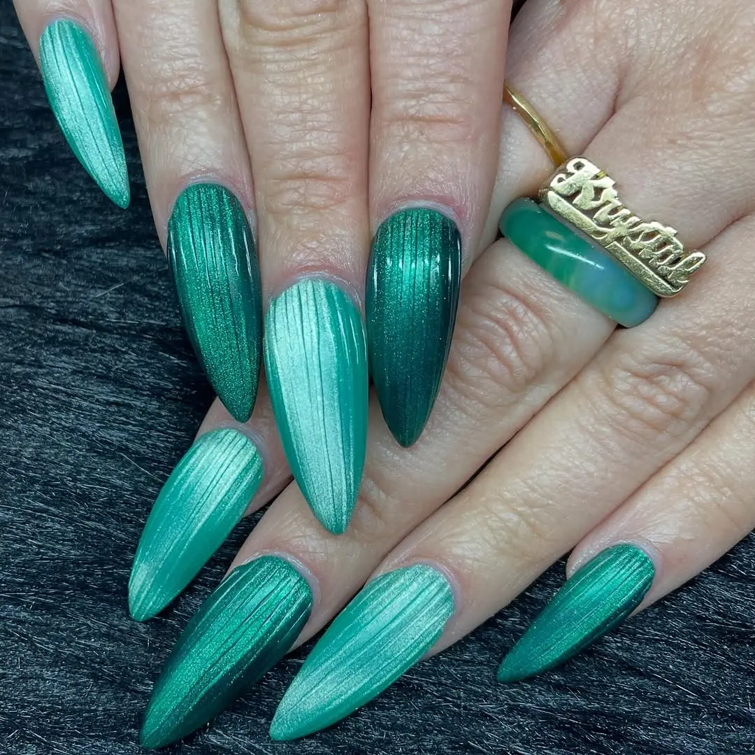 Stunning teal ribbed glass stiletto nails design