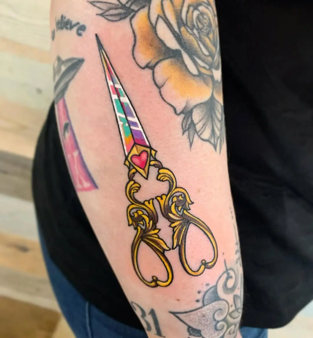 Colorful scissors tattoo celebrating hairstyling artistry