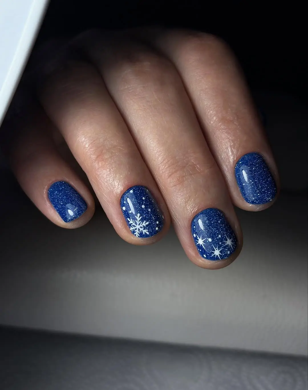 Sparkling blue winter nails with snowflakes