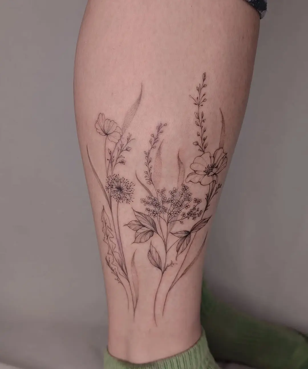 Elegant wildflower tattoo highlighting natural beauty.