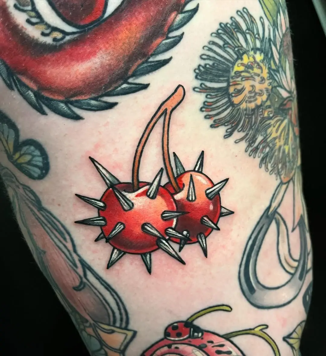 Bold spiked cherry tattoo with vibrant colors