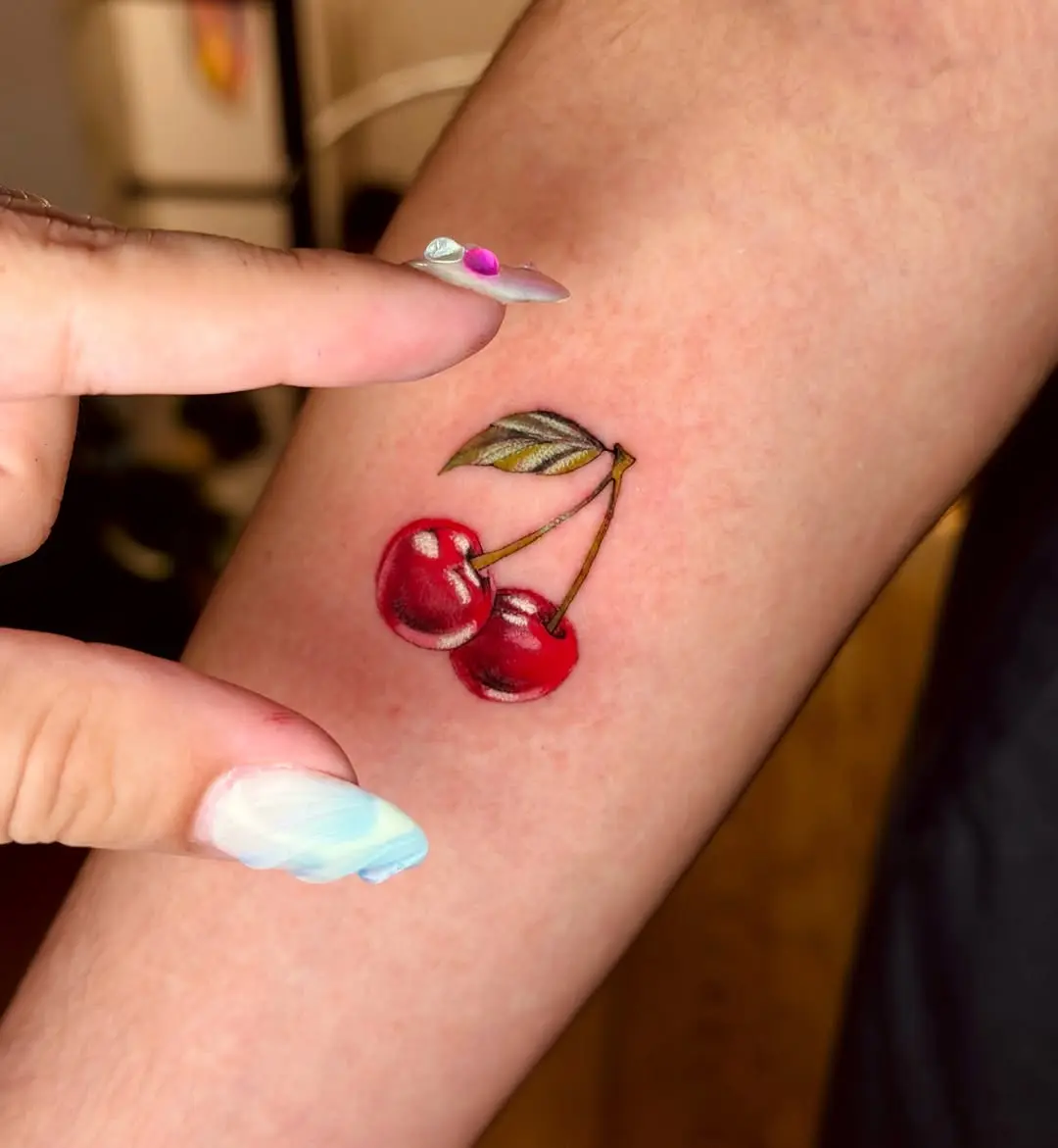 Stylish cherry tattoo on a woman's arm
